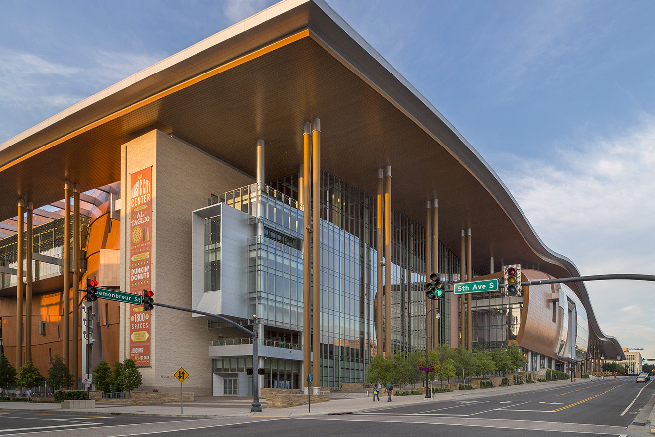 Wide daytime view of the Music City Center with the banner on the facade